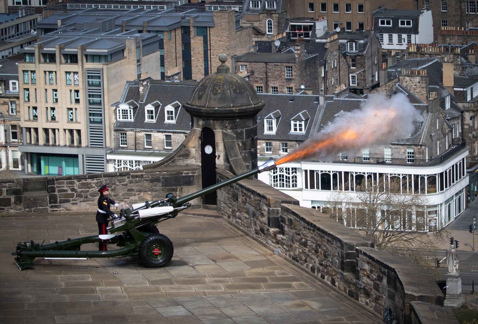 Sgt. David Beveridge fires a gun salute from the ramparts of Scotland's Edinburgh Castle.