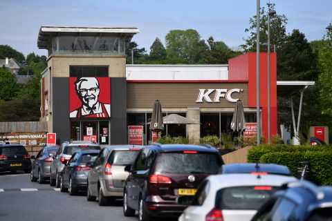 A long line of cars forms as a KFC drive-thru reopens in Plymouth, England, on May 8.
