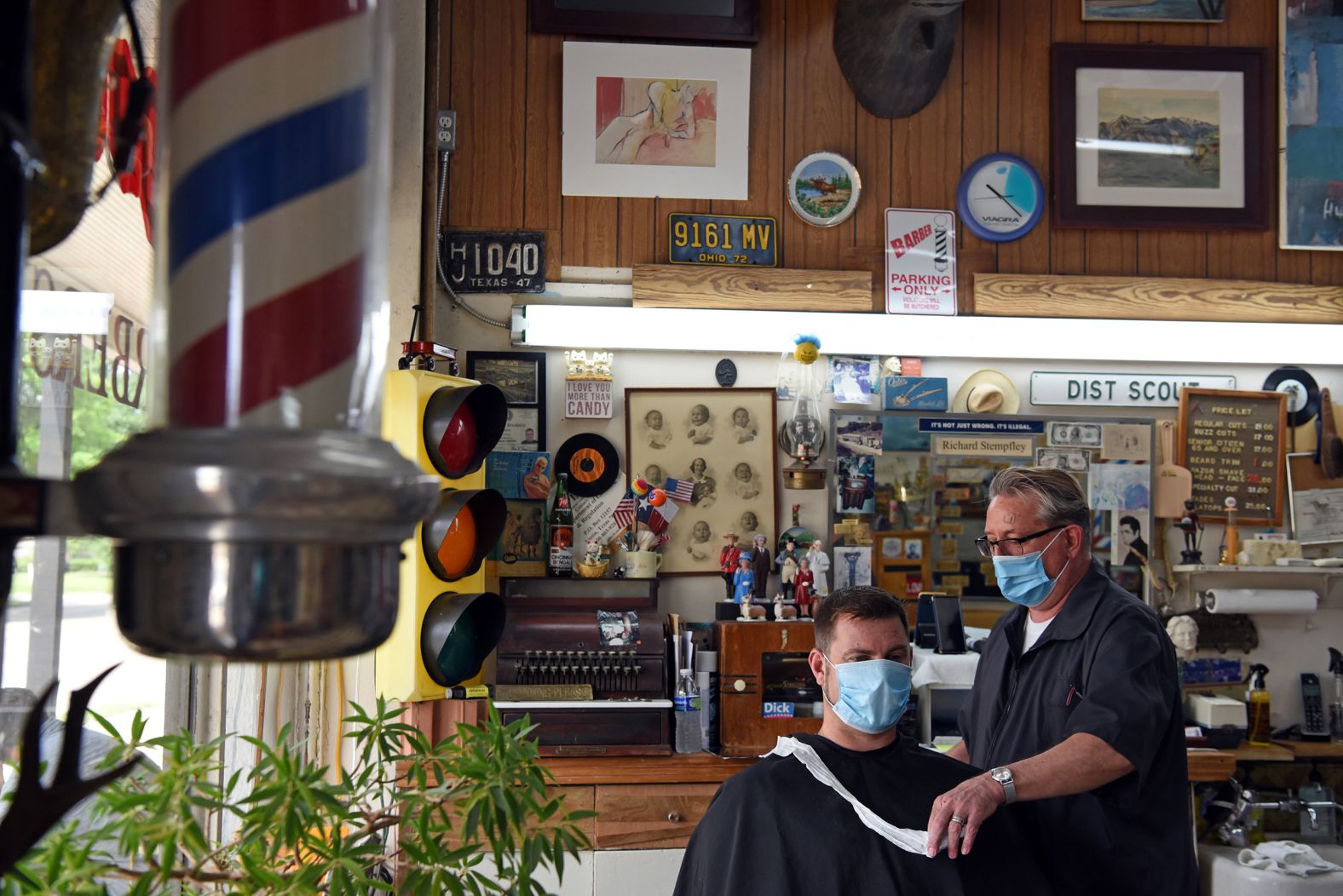 A man receives a haircut at Doug's Barber Shop in Houston on May 8.