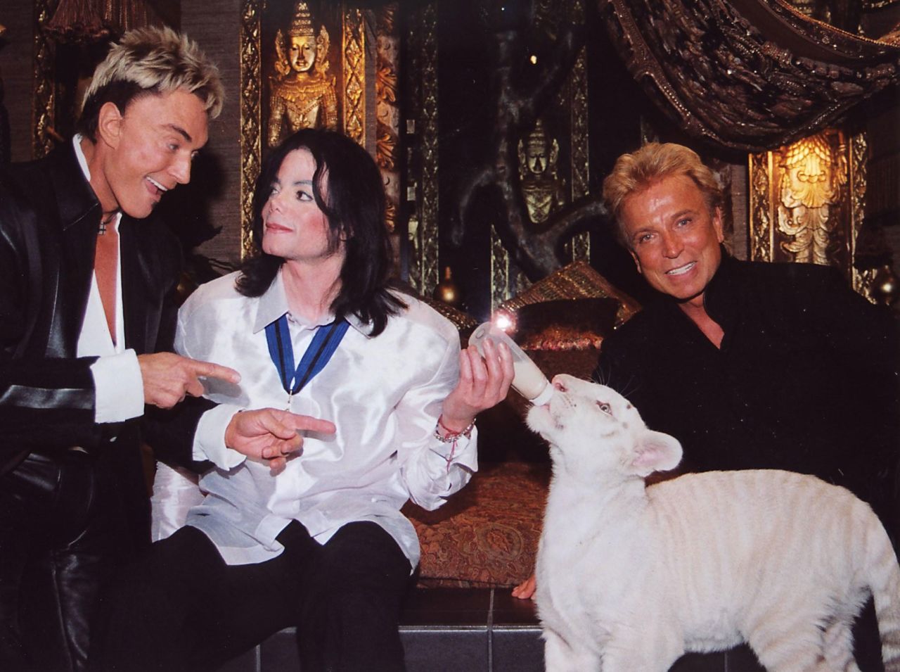 Fischbacher and Horn talk with pop star Michael Jackson as he feeds one of their tigers in Las Vegas in 2002.