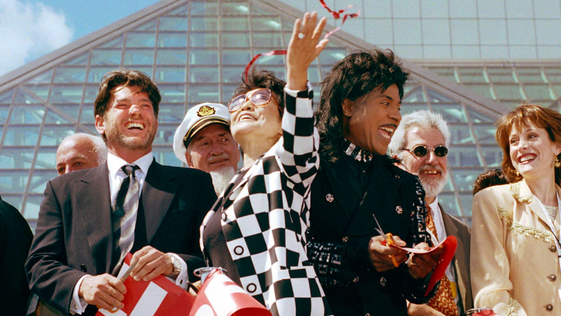 Rolling Stone publisher Jann Wenner, left, Yoko Ono, center, and Little Richard celebrate after cutting the ribbon to open the Rock and Roll Hall of Fame and museum in Cleveland in 1995.