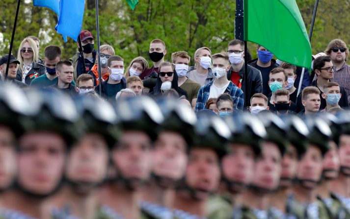 People wear face masks while watching a Victory Day military parade in Minsk, Belarus, on May 9, 2020. The parade marked the 75th anniversary of the Allied victory over Nazi Germany in World War II.