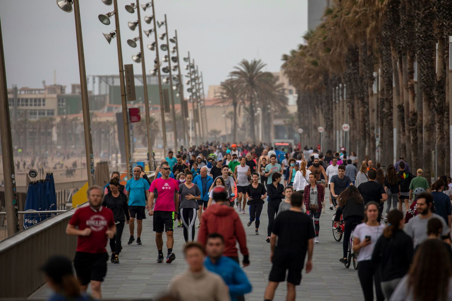 People exercise on a reopened promenade next to a beach in Barcelona, Spain, on May 9.