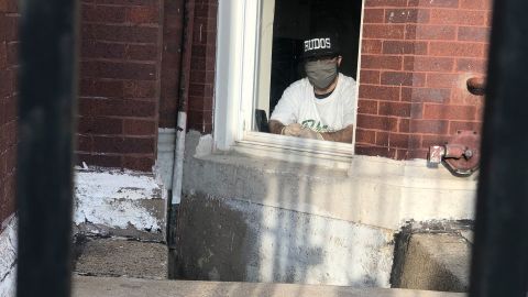 Alex "Demo" Ramirez speaks to CNN through the window of his basement apartment. He was diagnosed with Covid-19 on May 1.