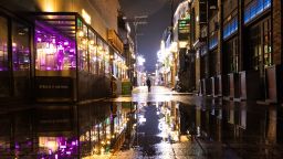 A person walks through the street at night in the Itaewon area of Seoul, South Korea, on Saturday, May 9, 2020.