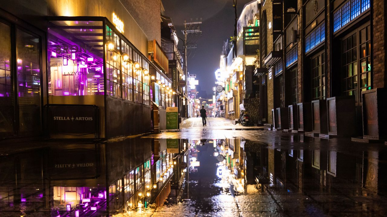 A person walks through the street at night in the Itaewon area of Seoul on Saturday.