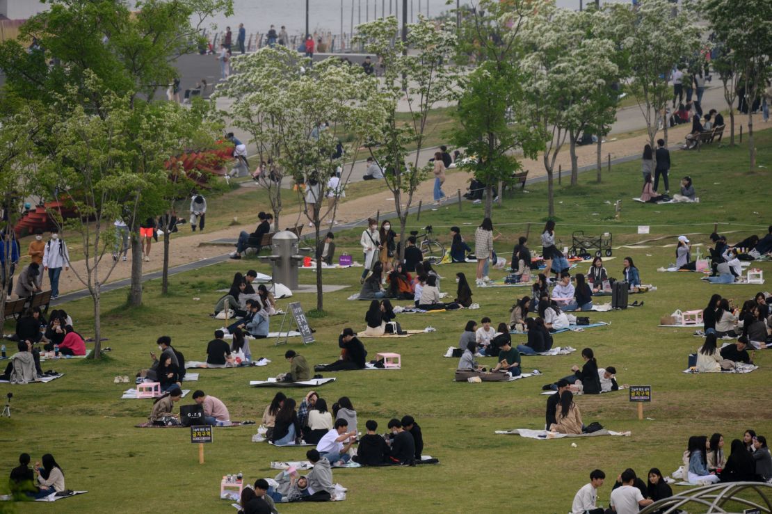 People sit in a park in Seoul, South Korea on Sunday. The country announced its highest number of new coronavirus cases for more than a month on Monday.