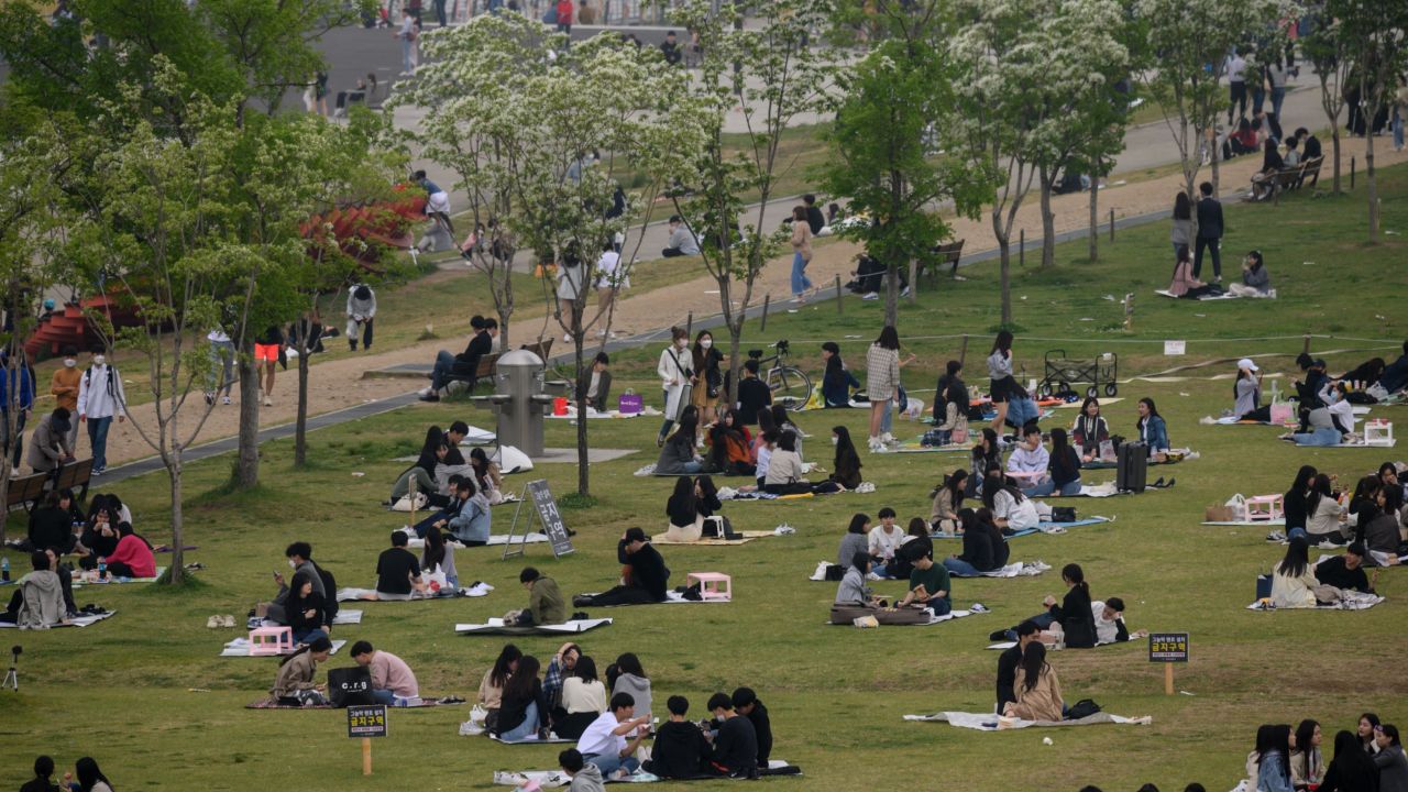 People sit in a park in Seoul, South Korea on Sunday. The country announced its highest number of new coronavirus cases for more than a month on Monday.
