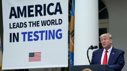 U.S. President Donald Trump, flanked by tables holding testing supplies and machines, speaks during a press briefing about coronavirus testing in the Rose Garden of the White House on May 11, 2020 in Washington, DC. 