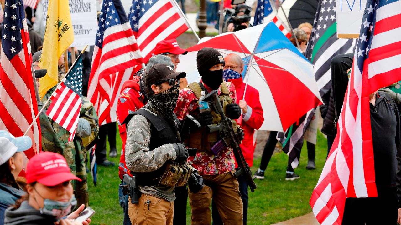 Armed protesters provide security as demonstrators take part in an "American Patriot Rally," organized by Michigan United for Liberty on the steps of the Michigan state capitol.