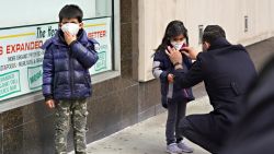NEW YORK, NEW YORK - APRIL 05: A man adjusts a child's protective mask amid the coronavirus pandemic on April 05, 2020 in New York City. COVID-19 has spread to most countries around the world, claiming almost 70,000 lives with infections nearing 1.3 million people.  (Photo by Cindy Ord/Getty Images)