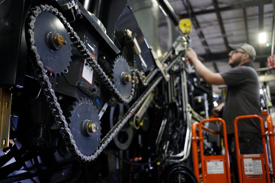 A worker assembles a combine harvester in a production facility in Omaha, Nebraska.