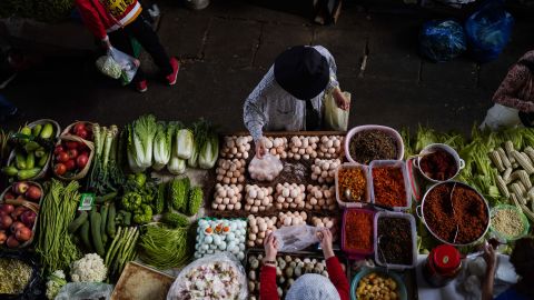 A customer buys eggs at a market in Kunming, China, on May 12.
