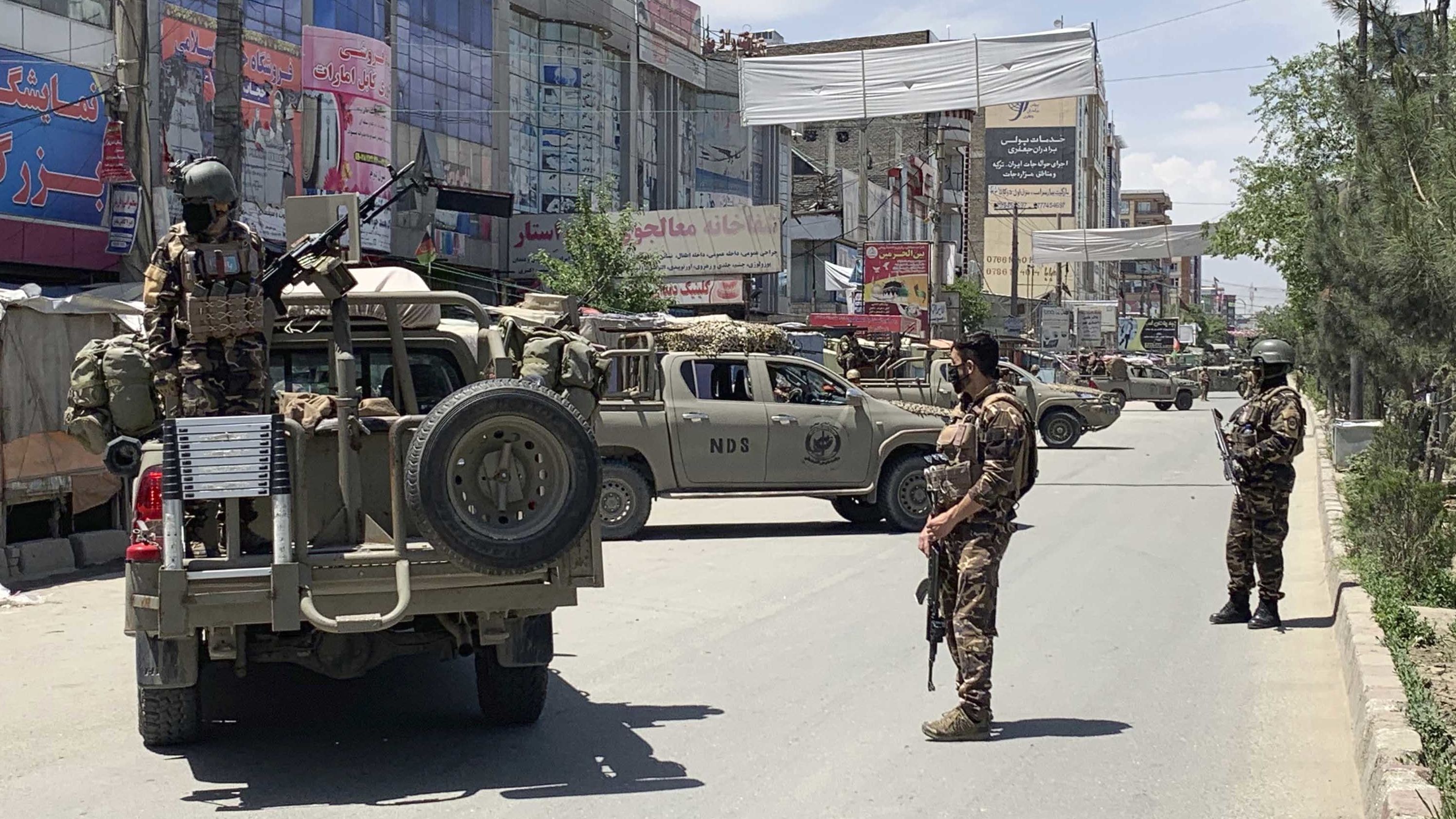 Afghan security personnel arrive at the site of the attack on the west side of the Afghan capital.