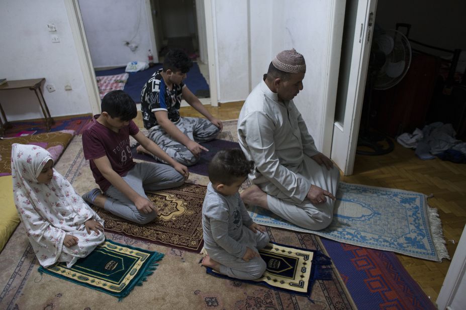 Syrian Fahad and his children pray after breaking their fast in Athens, Greece, on May 8.