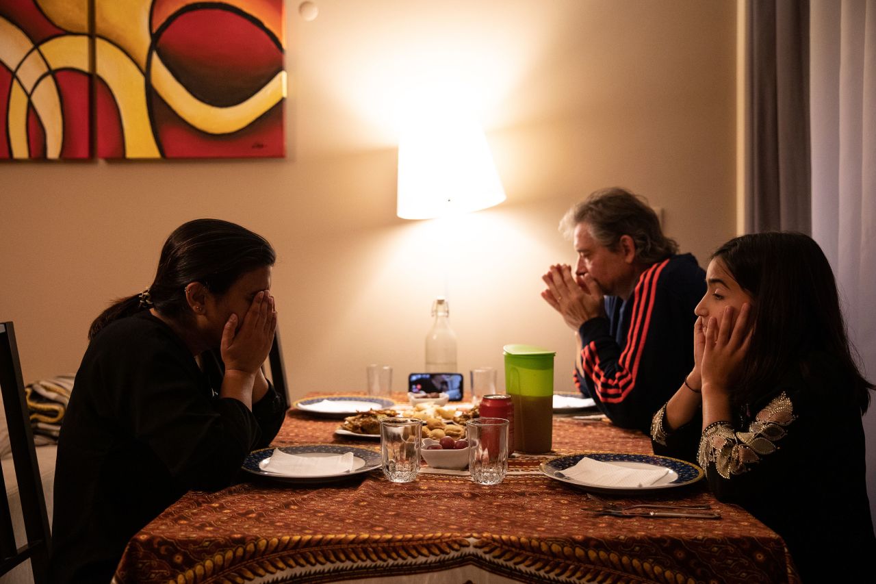 Rabia, Carlos and their daughter, A'sha, pray during their iftar meal in Lisbon, Portugal, on May 10. They usually break fast at the home of Rabia's parents, who can be seen on the video call here.