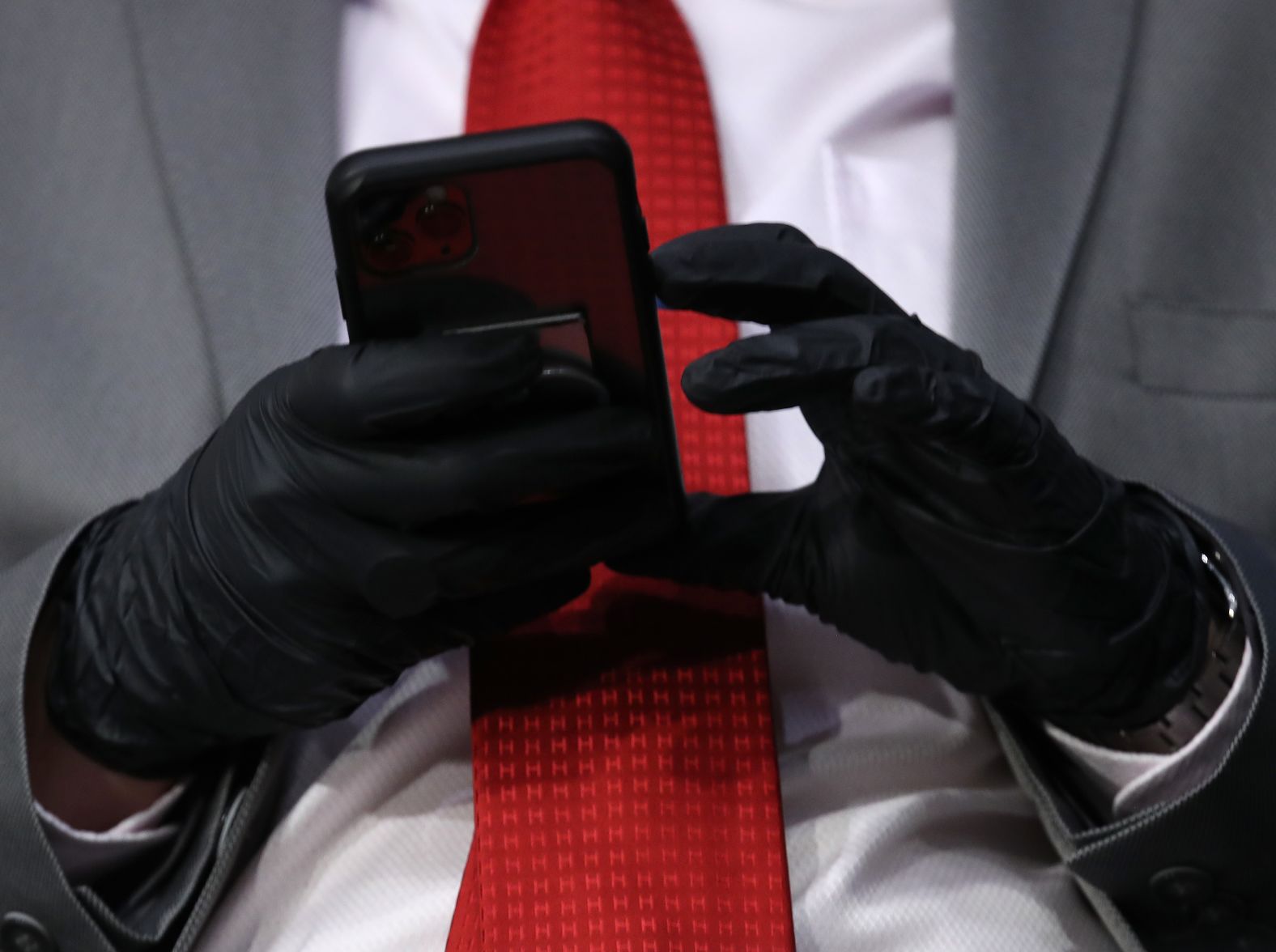 A Senate staffer wears protective gloves during the hearing.