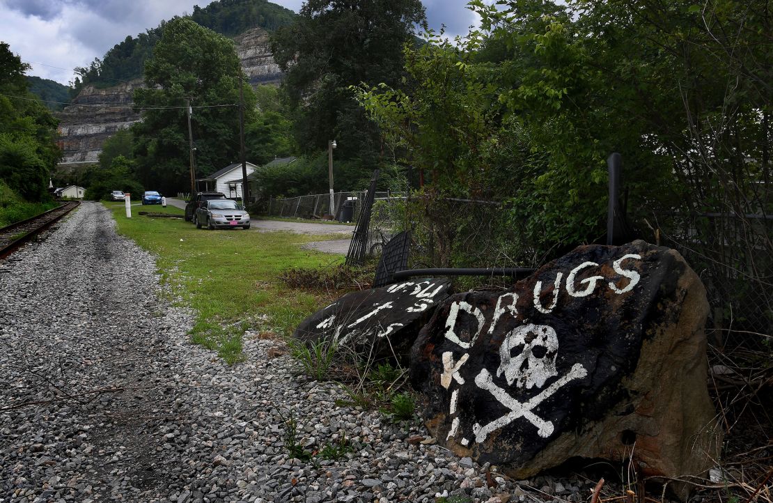 An ominous sign painted on rocks in rural Logan County, West Virginia, speaks to rural Appalachia's addiction crisis.