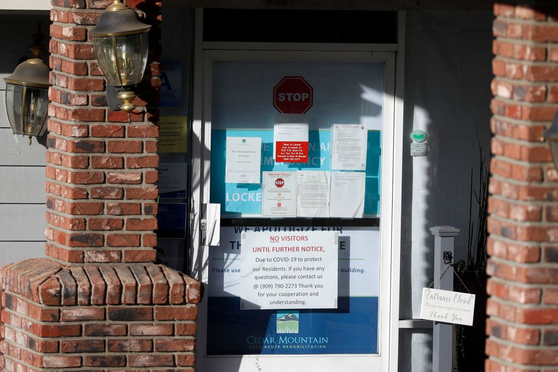 Warning notices were posted on a door at an entrance to the Cedar Mountain Post Acute nursing facility in Yucaipa, Calif. There have been 21 resident deaths there -- the highest number of Covid-19 deaths in any facility in San Bernardino County.