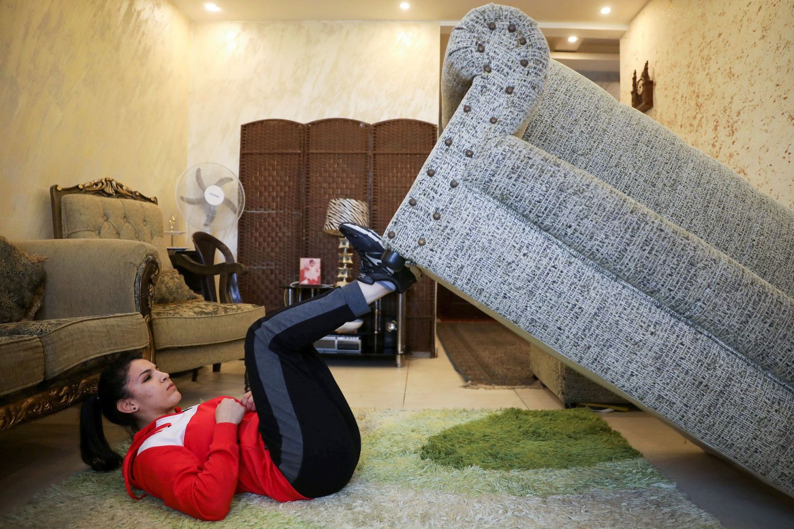 Hadeel Alami, a judo practitioner and Olympic hopeful, trains with her sofa in Amman, Jordan, on April 9.