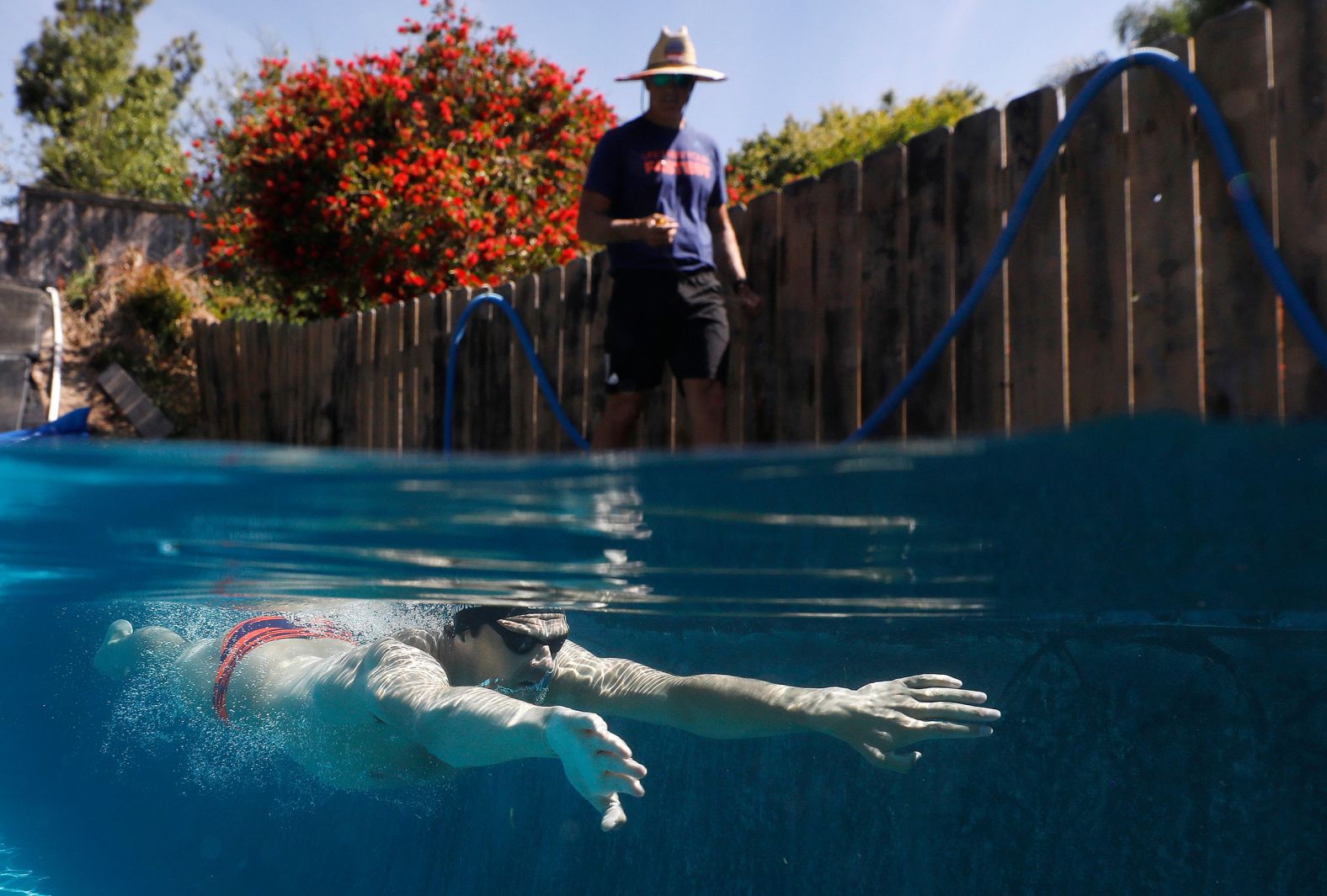 US Olympian Michael Andrew is coached by his father, Peter, as he trains in a residential pool in San Diego on May 6.