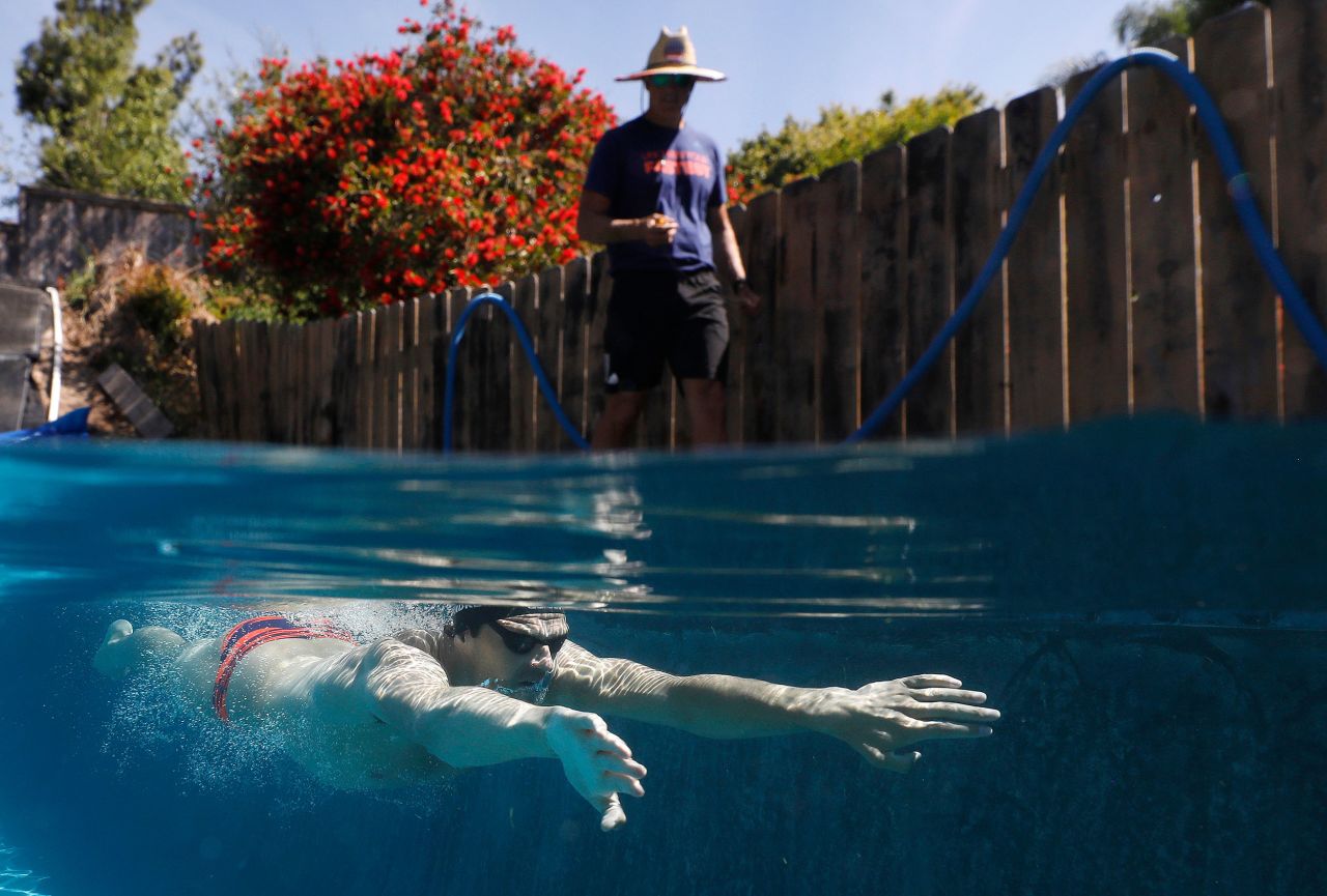 US Olympian Michael Andrew is coached by his father, Peter, as he trains in a residential pool in San Diego on May 6.