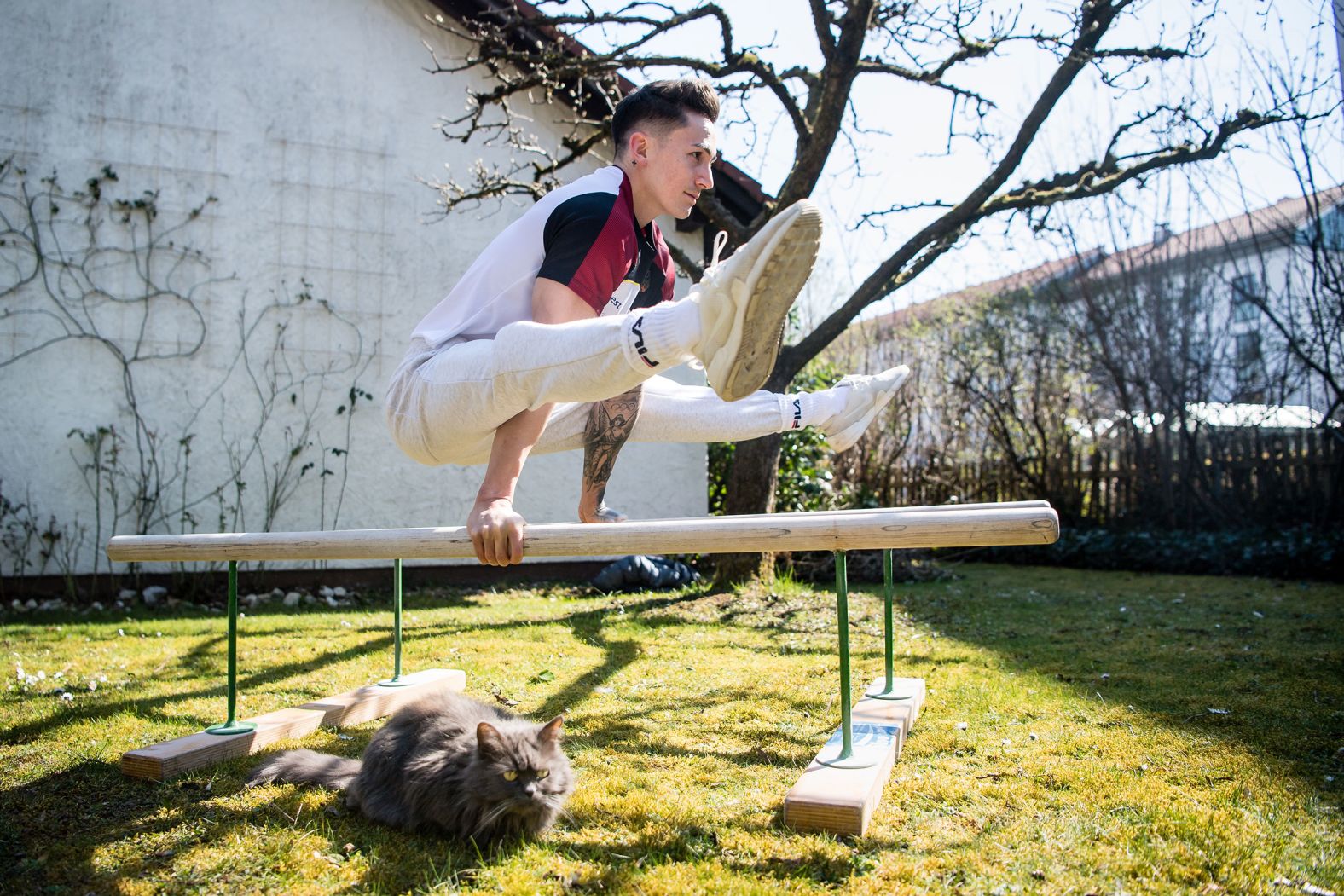 German gymnast Marcel Nguyen, who won two silver medals at the 2012 Olympics, trains in his mother's garden in Unterhaching, Germany, on March 24.