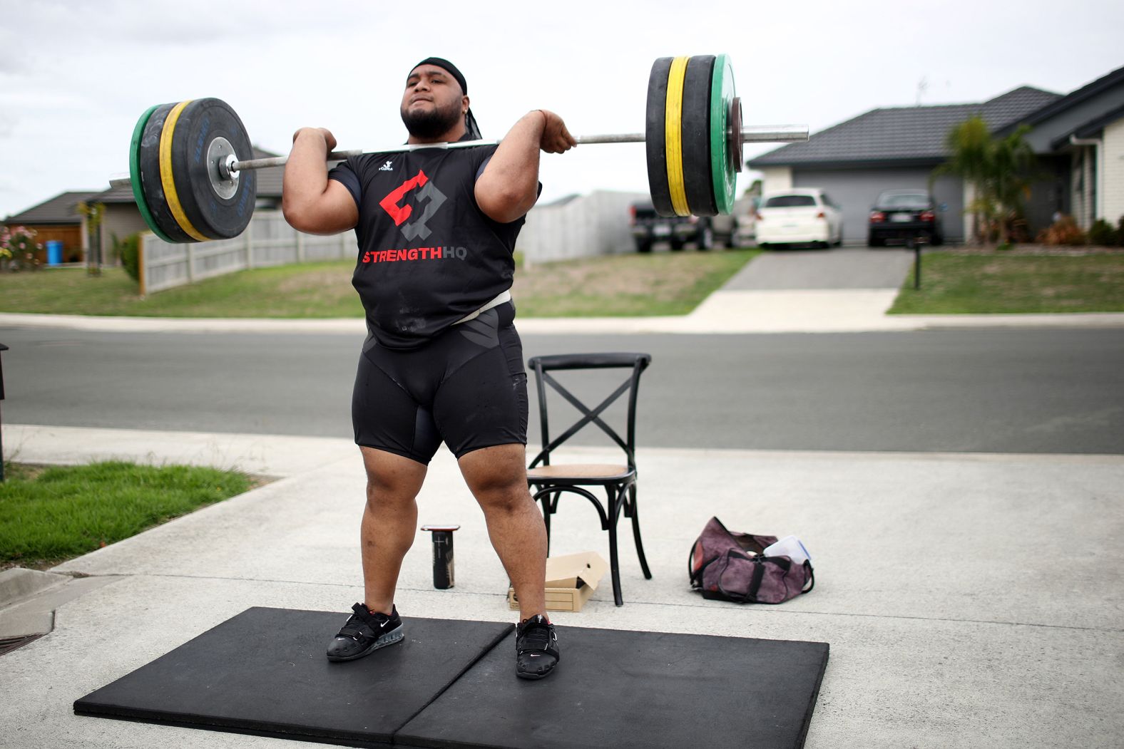 Weightlifter David Liti, who won gold at the 2018 Commonwealth Games, lifts in his driveway in Te Kauwhata, New Zealand, on April 8.