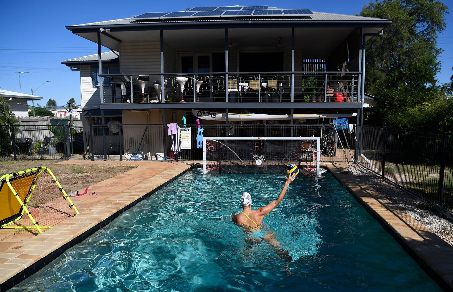 Water polo player Elle Armit practices shooting at her home in Townsville, Australia, on May 3.
