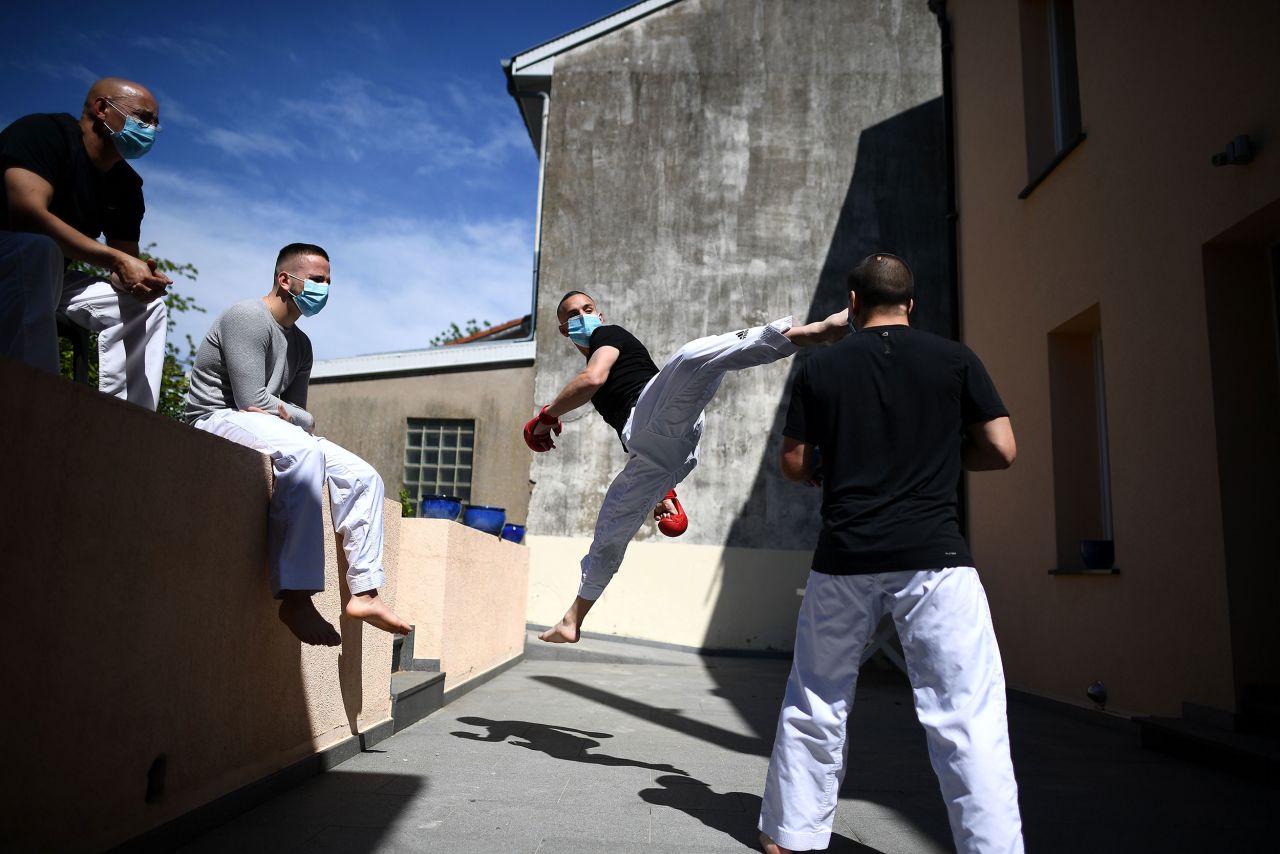 Steven Da Costa, a world champion in karate, works out with his brothers as their father, left, watches on the terrace of the family home in Mont-Saint-Martin, France, on May 5.