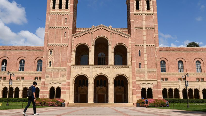 A student walks toward Royce Hall on the campus of University of California at Los Angeles (UCLA) in Los Angeles, California on March 11, 2020. - Starting this week many southern California universities including UCLA will suspend in-person classes due to coronavirus concerns.