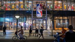 People walk by and sit outside the NBA flagship retail store on October 9, 2019 in Beijing, China. 