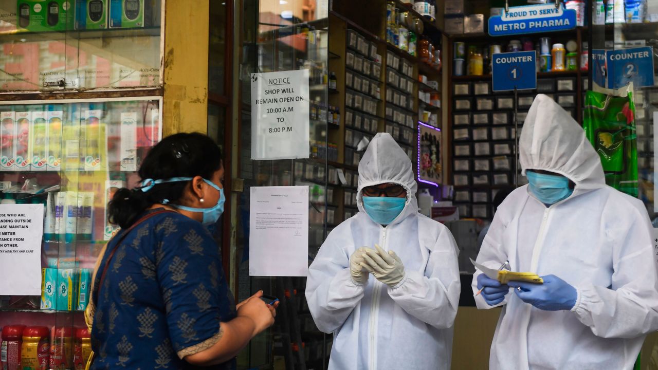 A pharmacy workers take an order of medicines from a customer outside the store as a preventive measure against the spread of the Covid-19 coronavirus in Kolkata on April 16, 2020.