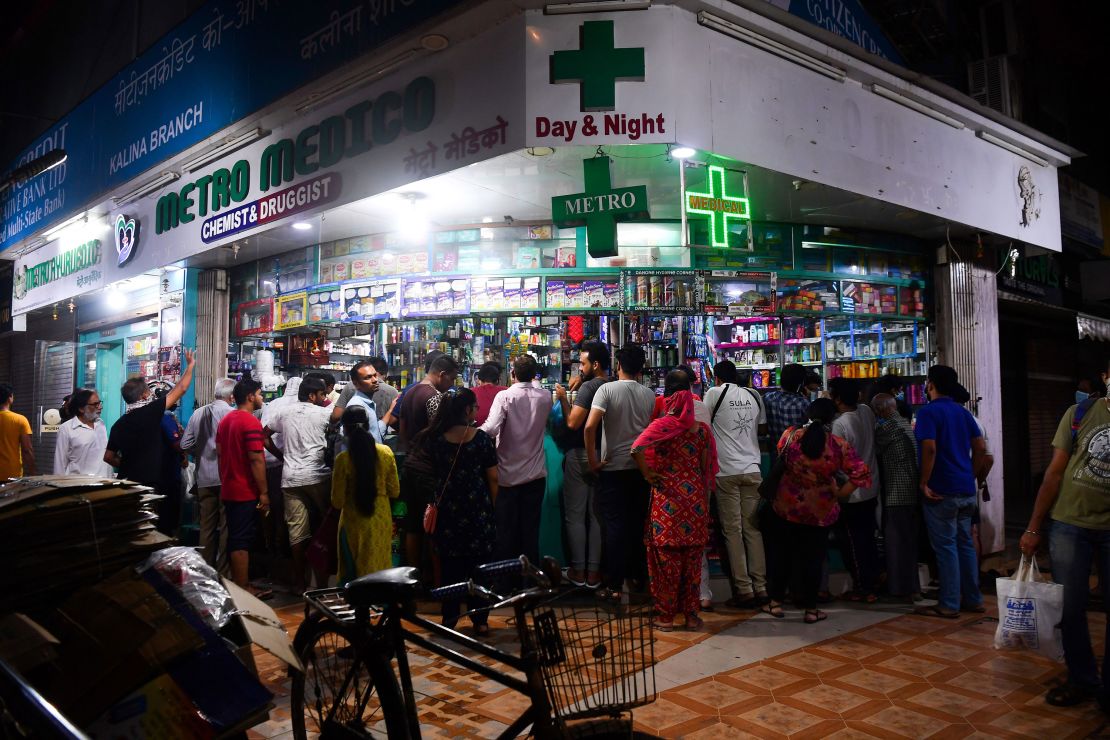 People gather at a pharmacy to buy supplies following Indian Prime Minister's announcement of a government-imposed nationwide lockdown as a preventive measure against the Covid-19 in Mumbai on March 24, 2020. 