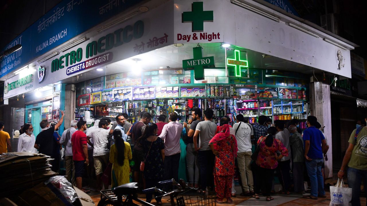 People gather at a pharmacy to buy supplies following Indian Prime Minister's announcement of a government-imposed nationwide lockdown as a preventive measure against the Covid-19 in Mumbai on March 24, 2020. 