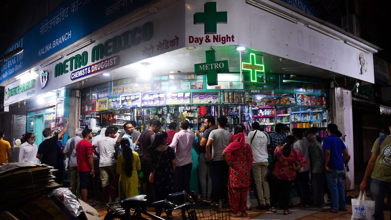 People gather at a pharmacy to buy supplies following Indian Prime Minister's announcement of a government-imposed nationwide lockdown as a preventive measure against the Covid-19 in Mumbai on March 24, 2020.