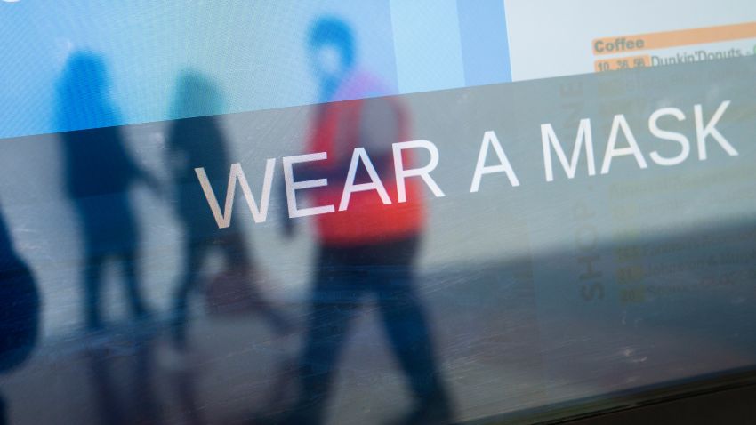 ARLINGTON, VA - MAY 05: The arrivals board displays a message about wearing masks at Ronald Reagan Washington National Airport, May 5, 2020 in Arlington, Virginia. Most major airlines are now requiring passengers to wear face coverings to help prevent the spread of the coronavirus. (Photo by Drew Angerer/Getty Images)