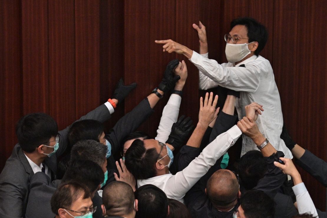 Pro-democracy lawmaker Eddie Chu Hoi-dick shouts at security trying to restrain him during an angry Legislative Council session in Hong Kong on May 8, 2020.