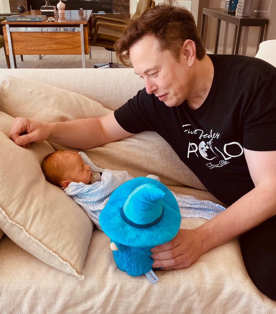 Musk looks at his new baby boy in <a  target="_blank" target="_blank">this tweet </a>posted by his mother in May 2020. The baby, <a  target="_blank">named X ? A-12</a>, is his first child with Grimes. He has five other children from a previous marriage.