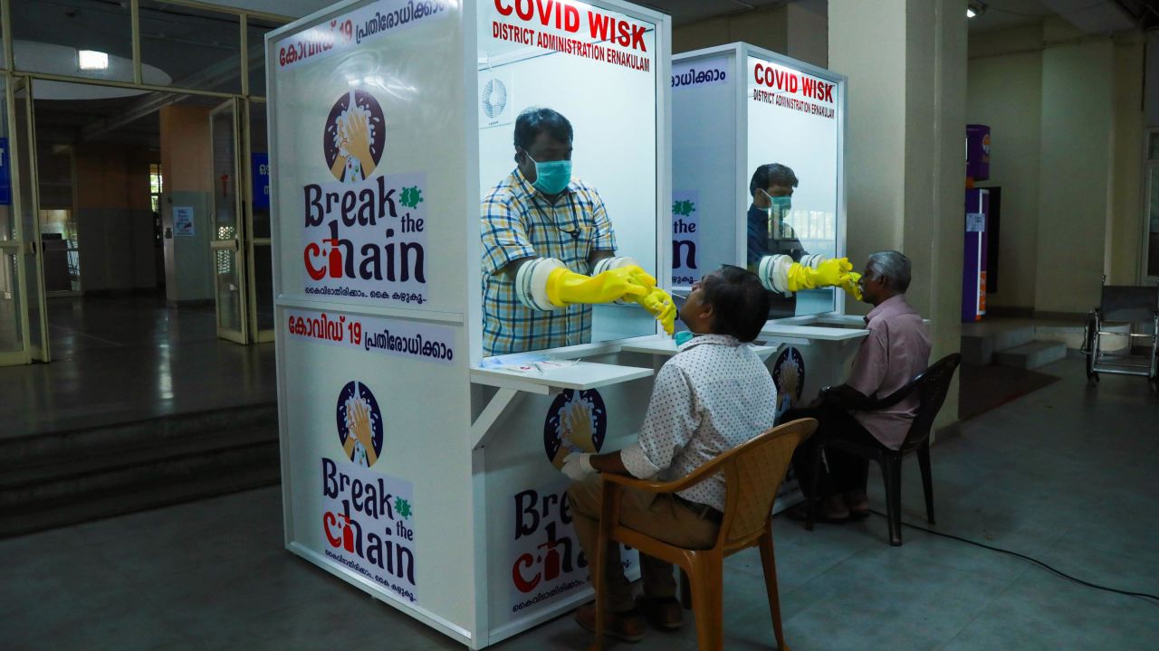 Medical staff collect samples from people at a kiosk to test for Covid-19 in Kerala, India, on April 6, 2020.