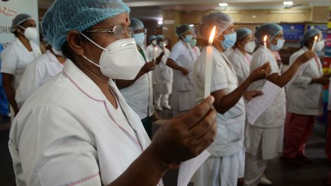 Nurses light candles at Rajiv Gandhi hospital in Kochi, Kerala, on May 12, 2020, to mark International Nurses Day, celebrated on the birthday of Florence Nightingale.