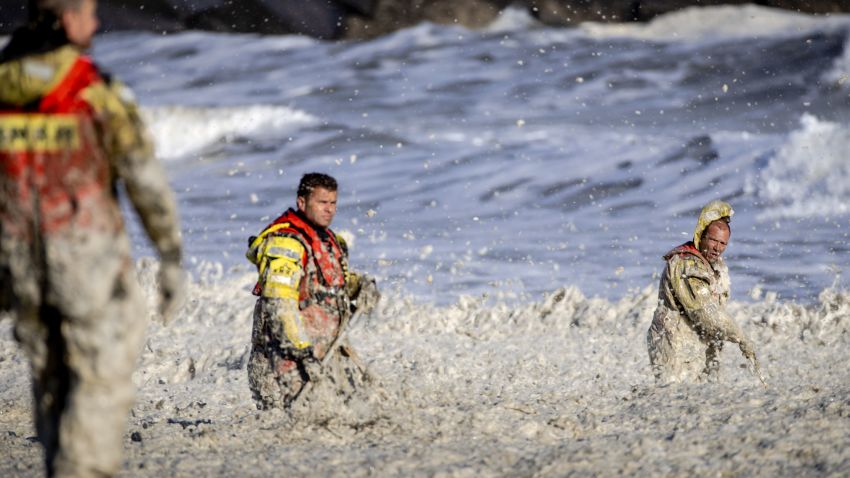 Rescue workers stand in rough waters during the resumed search for missing water sports participants in The North Sea at Scheveningen, The Netherlands on May 12, 2020. - The coastguard, police, fire brigade and KNRM are looking for potentially an additional three missing persons after May 11, when two surfers who were taken out of the sea have died. (Photo by Sem VAN DER WAL / ANP / AFP) / Netherlands OUT (Photo by SEM VAN DER WAL/ANP/AFP via Getty Images)