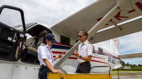 Joyce Lin, left, and fellow pilot Kees Janse prepare for a flight in Wamena, Indonesia.