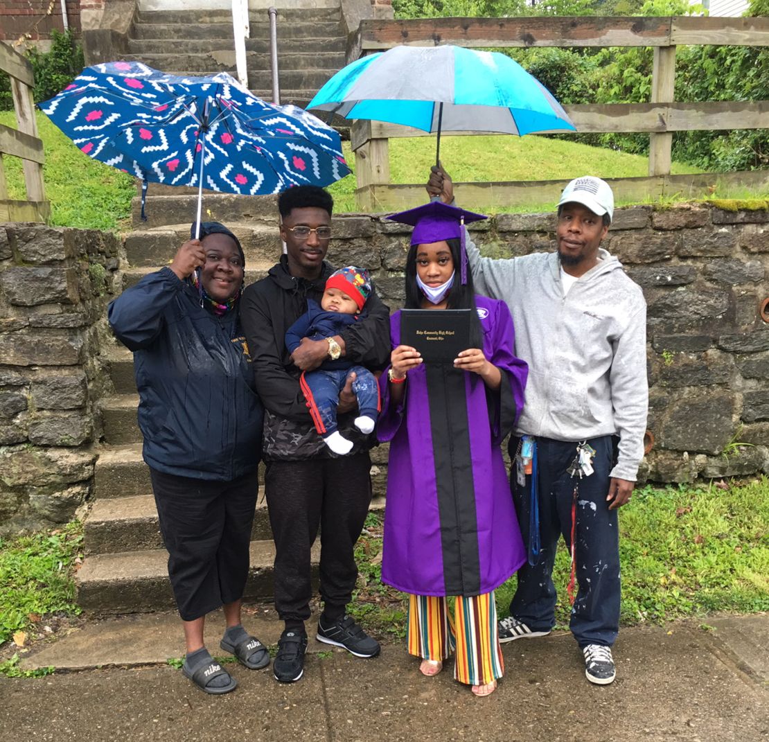 Takela Thomas and her family celebrate her high school graduation in front of their home.