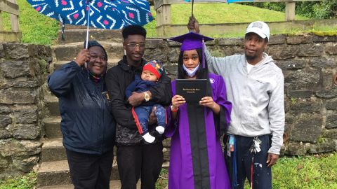 Takela Thomas and her family celebrate her high school graduation in front of their home.