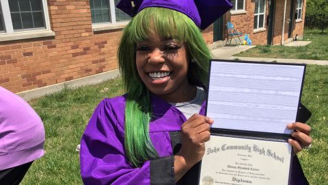 Asiana Carter celebrates her high school graduation in her front yard. 