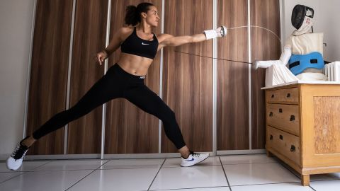 Fencer Alexandra Ndolo trains with a self-made puppet at her apartment in Cologne, Germany, on April 9.
