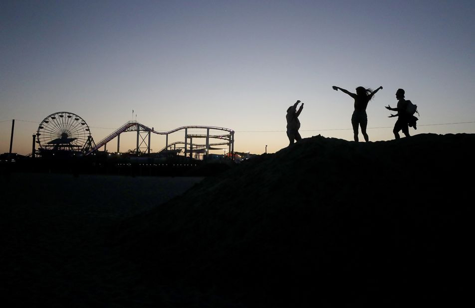 People dance at dusk on the beach in Santa Monica, California, on May 13. A stay-at-home order was still in place in Los Angeles County, but <a href="https://www.cnn.com/2020/05/12/health/us-coronavirus-tuesday/index.html" target="_blank">some restrictions were modified.</a> Beaches opened for runners, swimmers and surfers, but not sunbathers.