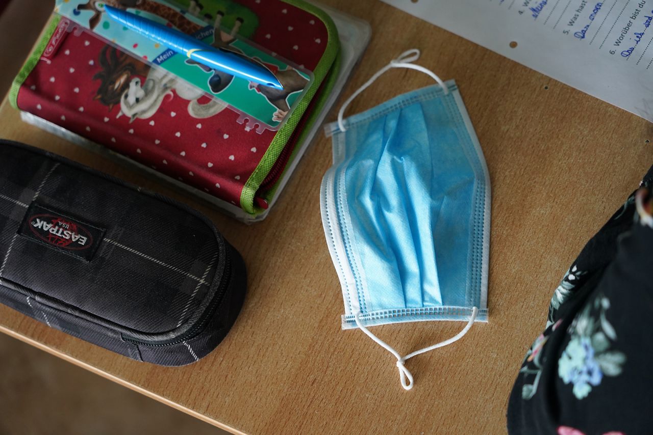A surgical mask lies on a sixth-grader's desk at the GutsMuths-Grundschule elementary school in Berlin on May 4. It was the first day of classes since March