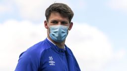 FC Schalke 04's German goalkeeper Alexander Nuebel walks with a face mask at the club's training grounds during a training session in Gelsenkirchen, western Germany on May 14, 2020. - Players arriving in several sparsely-populated team buses, substitutes wearing masks and goal celebrations limited to elbow bumps -- when German football returns to the pitch this weekend, it will have to follow a draconian set of guidelines. (Photo by Ina FASSBENDER / AFP) (Photo by INA FASSBENDER/AFP via Getty Images)